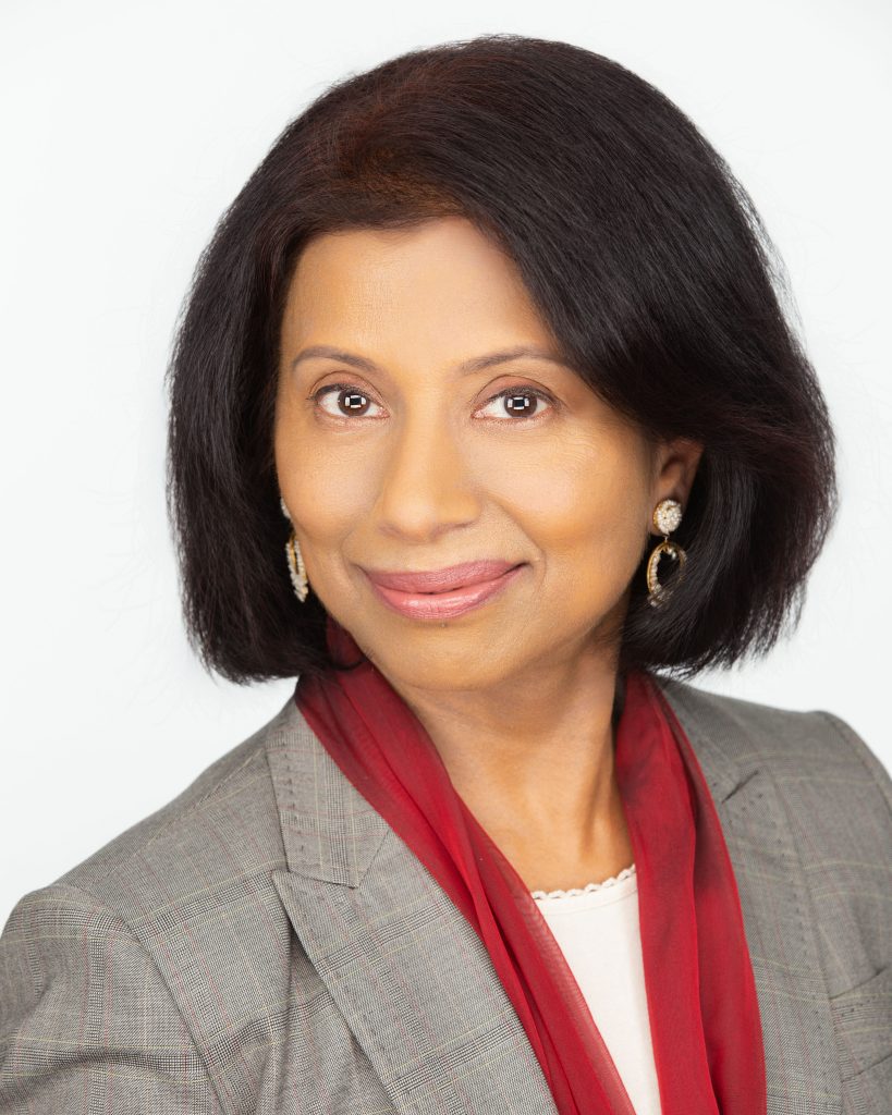 Female professional headshot smiling warmly into camera.