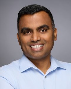 Studio portrait of male professional in neutral tones.